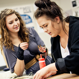 Students creating an artwork with glue