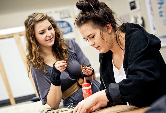 Students creating an artwork with glue