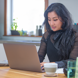 A student completes an assignment on her laptop