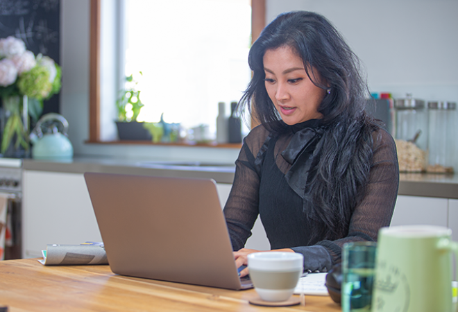 A student completes an assignment on her laptop