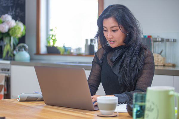 A student completes an assignment on her laptop