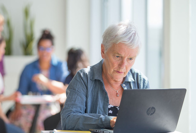 An educator using a laptop.