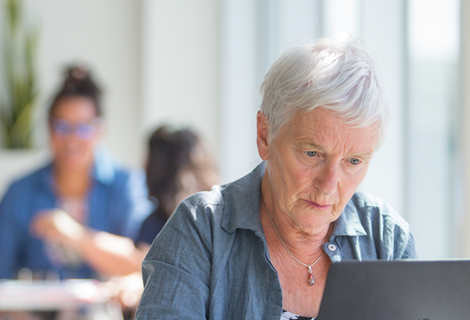 An educator using a laptop