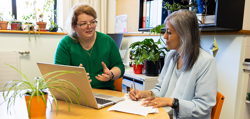 Claire Goode working with another teacher on a lesson plan