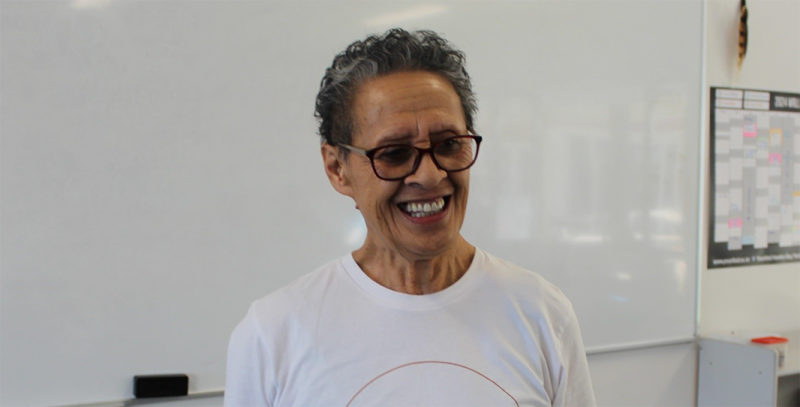 Hiria Tumoana standing in front of a whiteboard