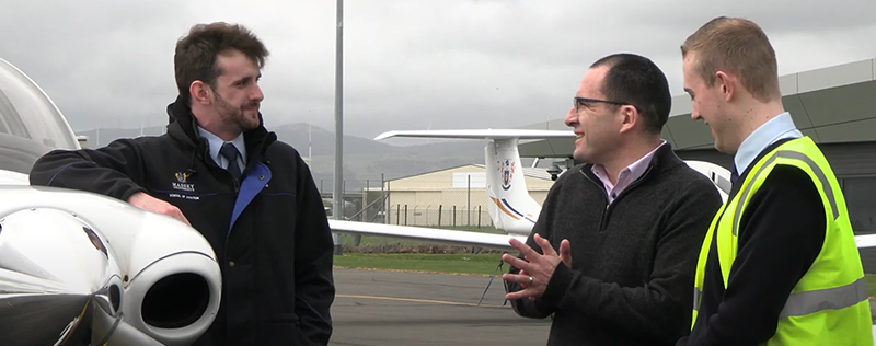 John Murrie and students next to an aeroplane