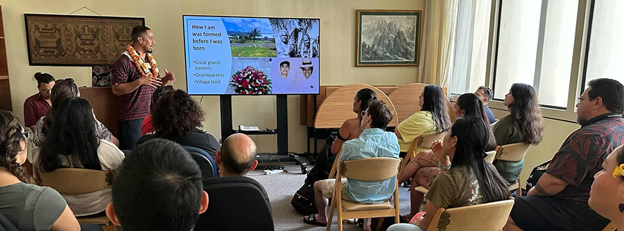 Dion Enari presents slides on his family history and culture