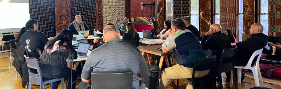 The MMIL team lead a discussion around the table