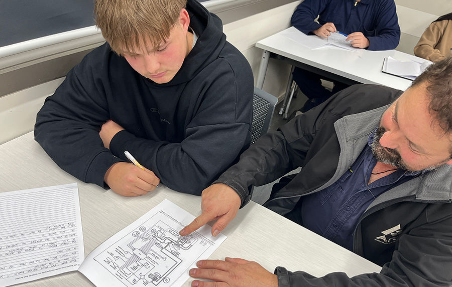 Richard explains a diagram to a student