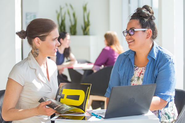 two learners discussing AI software